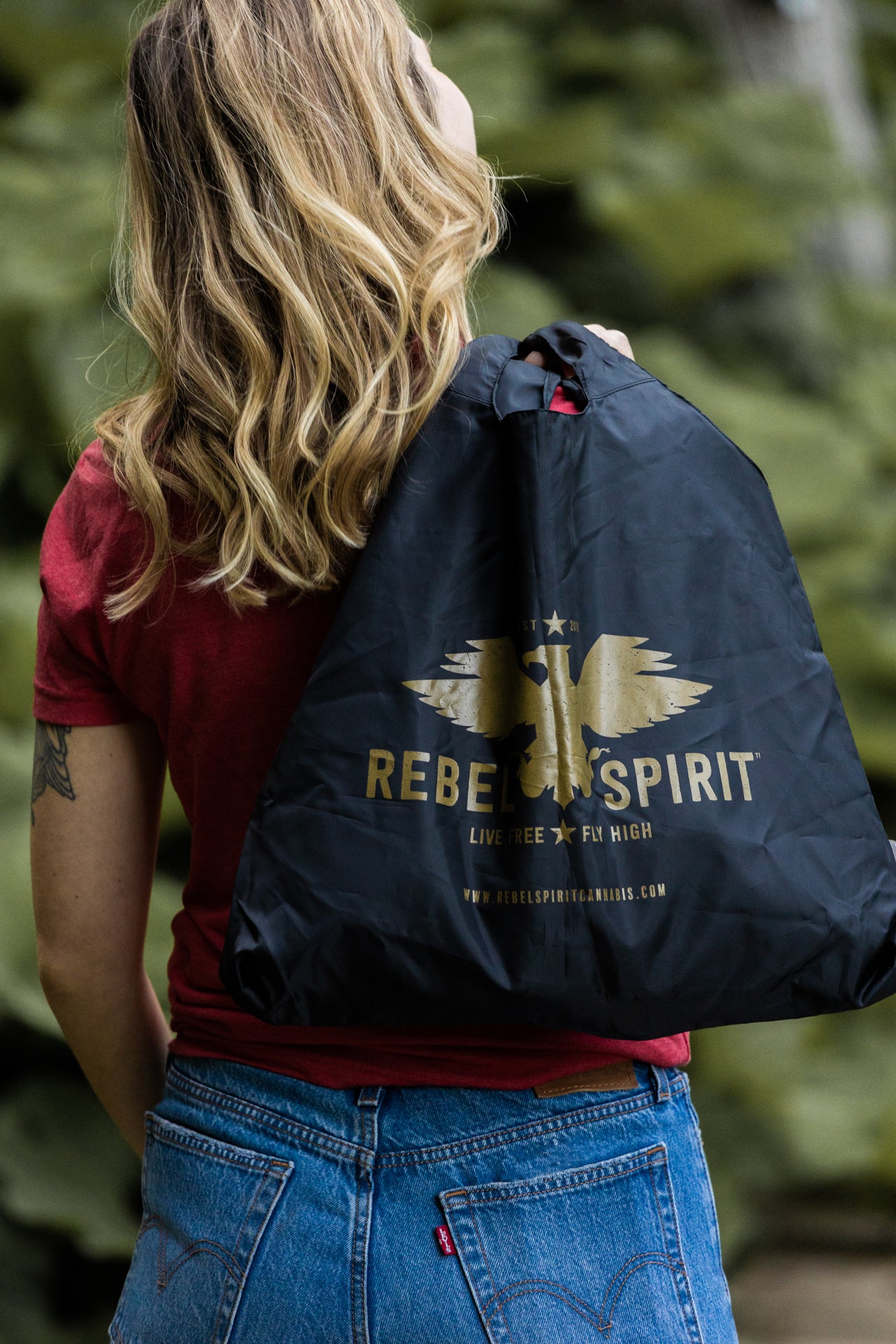 girl holding rebel spirit chico bag